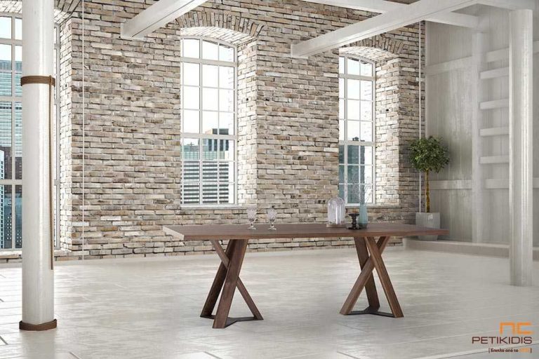 Τραπέζι Dune από ξύλο καρυδιάς με δύο κεντρικά πόδια από μασίφ καρυδιά με λεπτομέρεια μετάλλου στη βάση. Διαθέτει δυνατότητα προέκτασης.